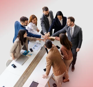 Business team joining hands together during a meeting